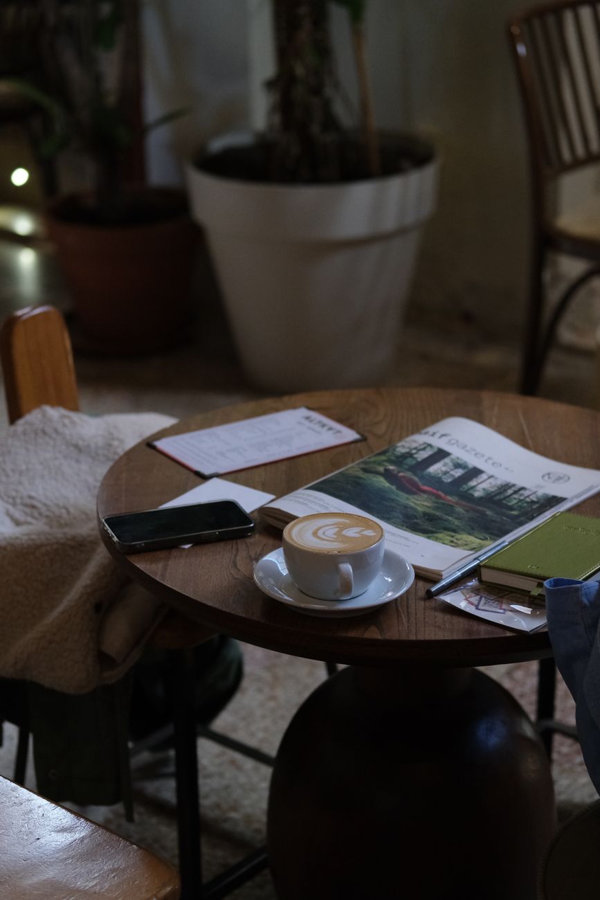 cozy coffee shop table with latte and magazines