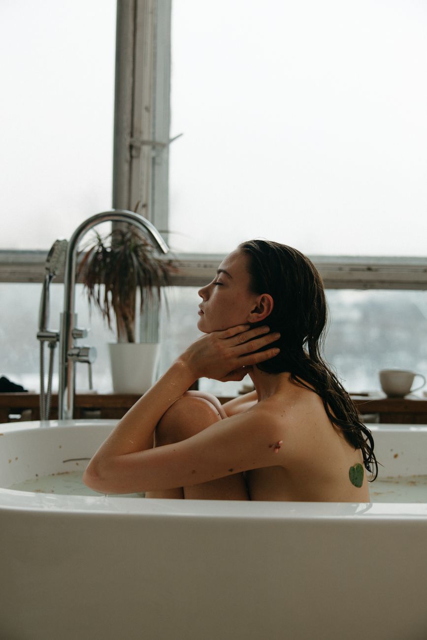 a woman sitting in the bathtub